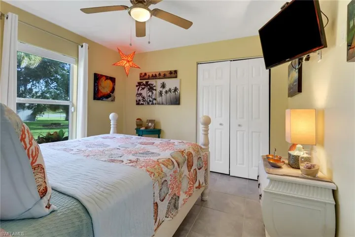 Tiled bedroom featuring a closet and ceiling fan