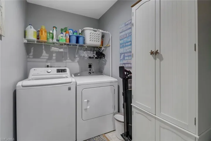 Laundry room featuring washer and dryer and cabinets