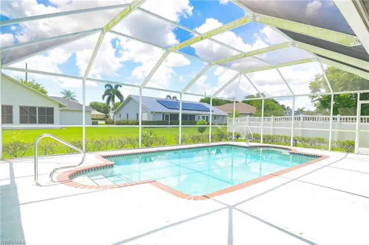 View of swimming pool with a patio, a lanai, and a yard