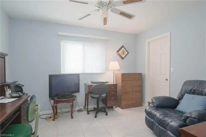 Office space featuring ceiling fan and light tile patterned floors