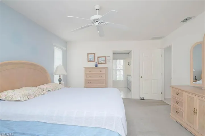 Carpeted bedroom featuring ceiling fan