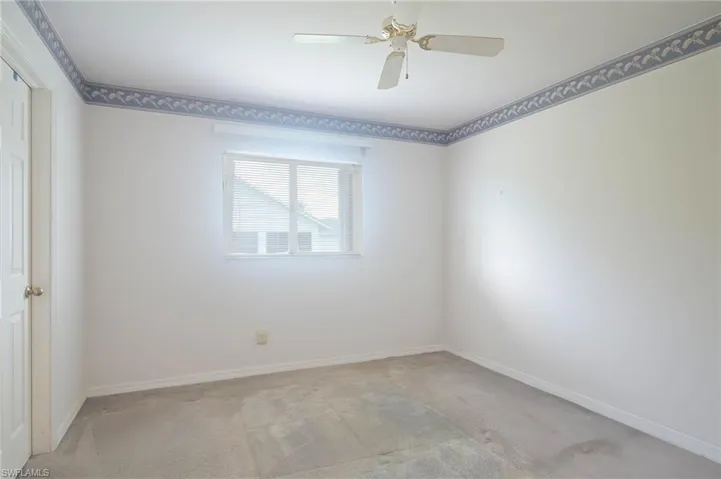 Empty room with carpet flooring and ceiling fan