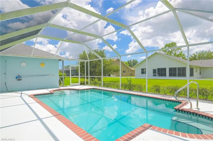 View of swimming pool with a lanai, a patio, and a yard