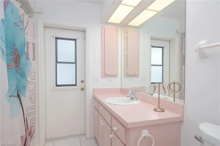 Bathroom featuring tile patterned floors, vanity, and toilet