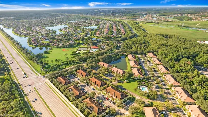 View of property location featuring a nearby body of water and nearby suburban area