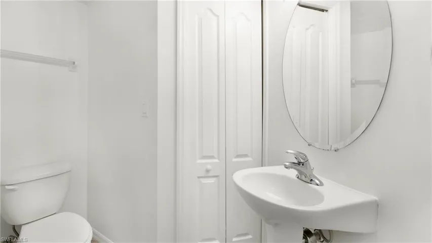Half bathroom with a closet and toilet