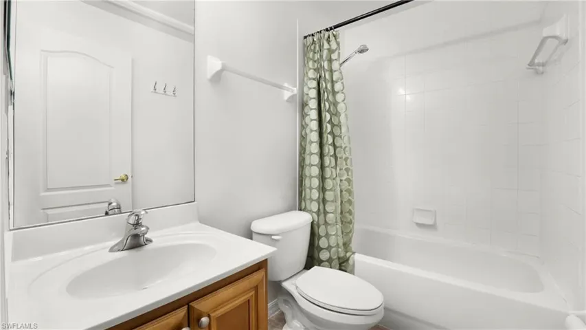 Full bathroom with shower / tub combo and vanity