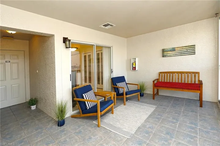Front lanai to front door with sliders to kitchen