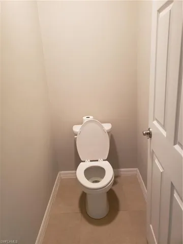 Bathroom featuring toilet and light tile patterned floors