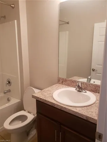 Bathroom featuring shower / washtub combination and vanity