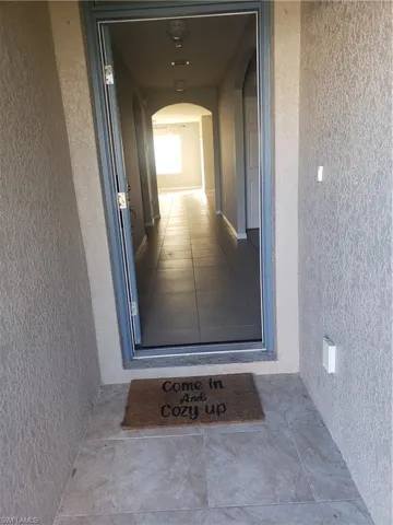 Doorway to property with stucco siding