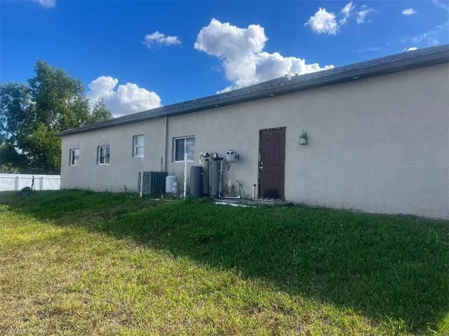 Rear view of house featuring stucco siding