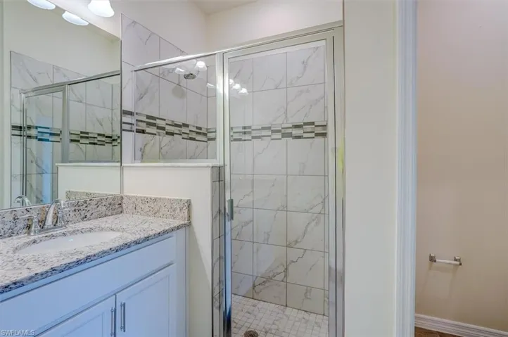 Bathroom featuring vanity and a shower with shower door