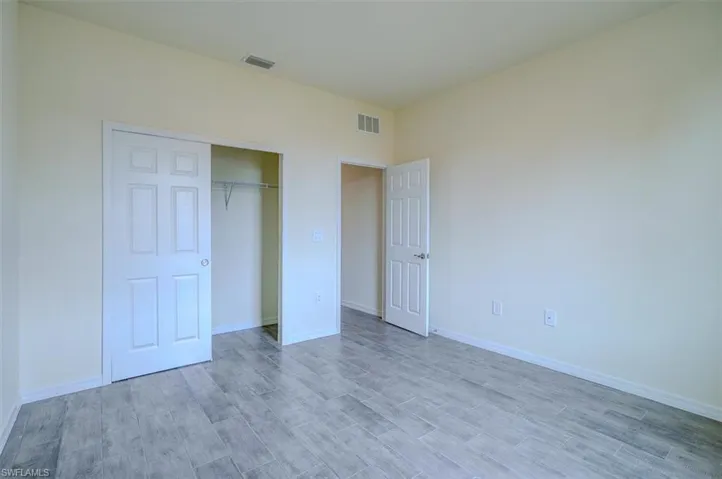 Unfurnished bedroom featuring a closet and light hardwood / wood-style flooring
