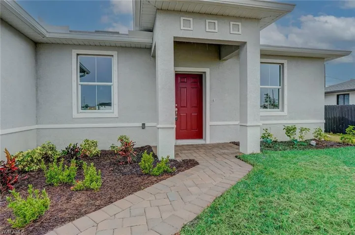 Entrance to property featuring a lawn