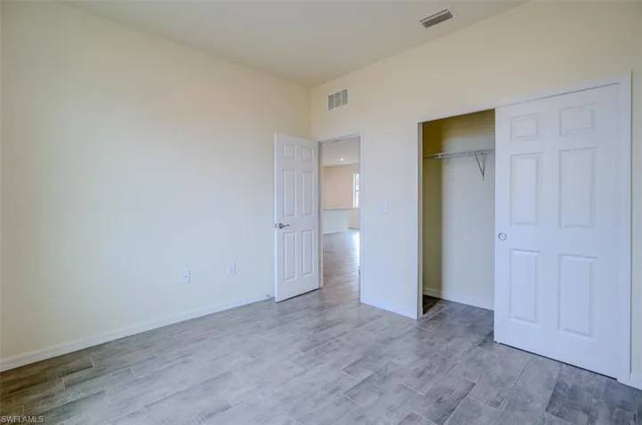 Unfurnished bedroom with light wood-type flooring and a closet