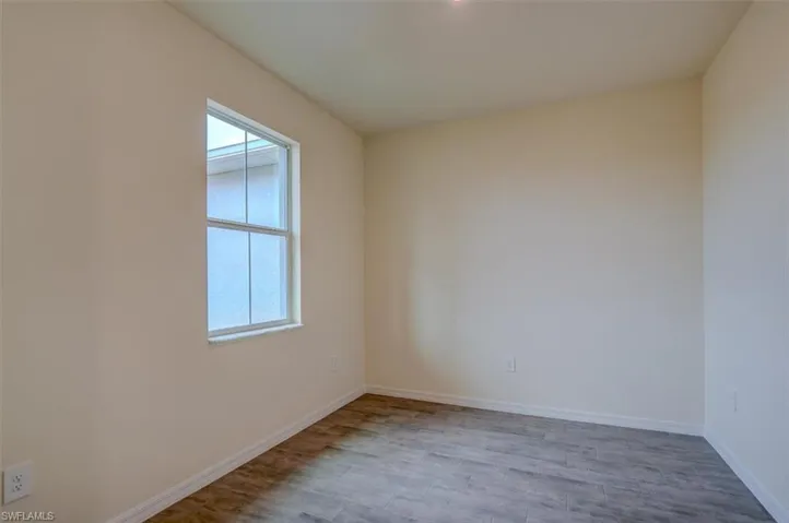 Spare room with light wood-style tile floors