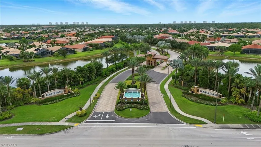 Aerial perspective of suburban area with a large body of water and skyline