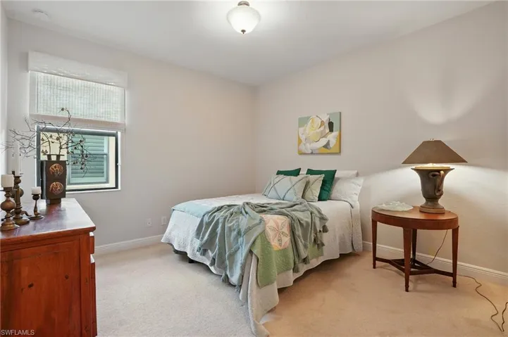 Bedroom featuring light carpet