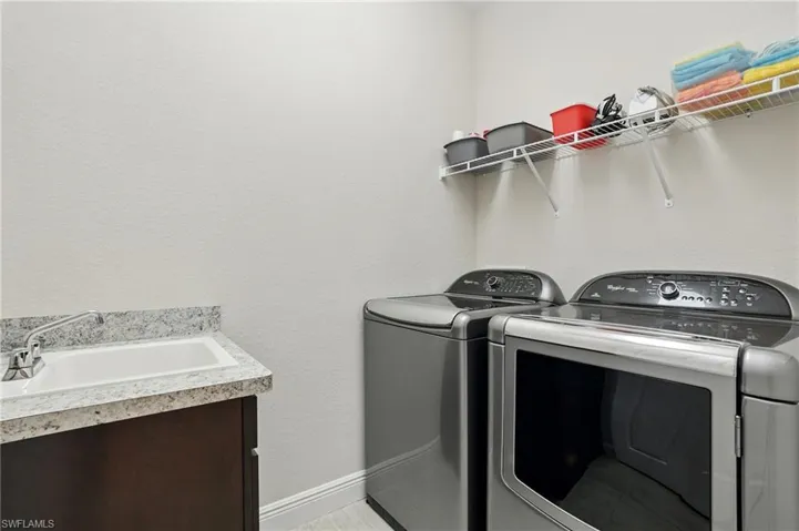 Laundry room featuring washing machine and dryer and cabinet space