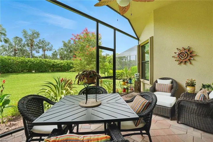 Sunroom with a ceiling fan and outdoor dining space