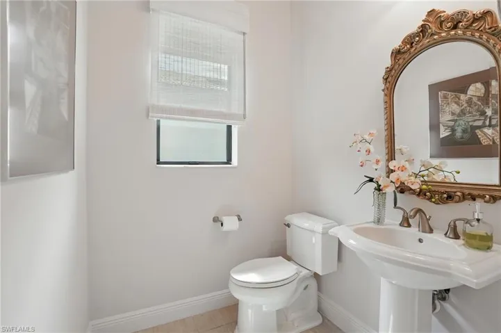 Bathroom featuring toilet and baseboards
