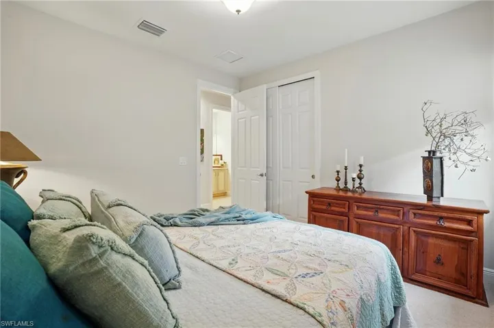 Carpeted bedroom with a closet and baseboards