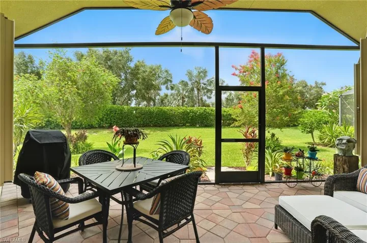 Sunroom featuring a ceiling fan and outdoor dining area