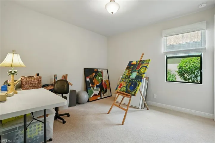 Carpeted office space with baseboards