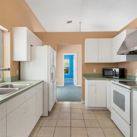 View from den, notice pass through to living room. Notice sliding windows above sink to porch
