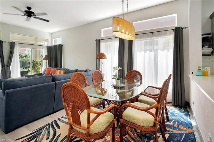 Dining space with ceiling fan and light hardwood / wood-style floors