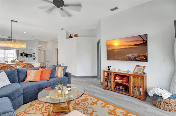 Living room featuring light hardwood / wood-style floors and ceiling fan