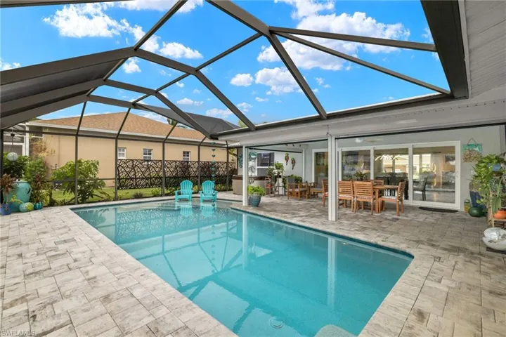 View of pool with a lanai and a patio