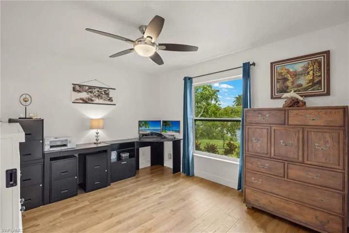 Office area featuring a healthy amount of sunlight, ceiling fan, and light hardwood / wood-style flooring