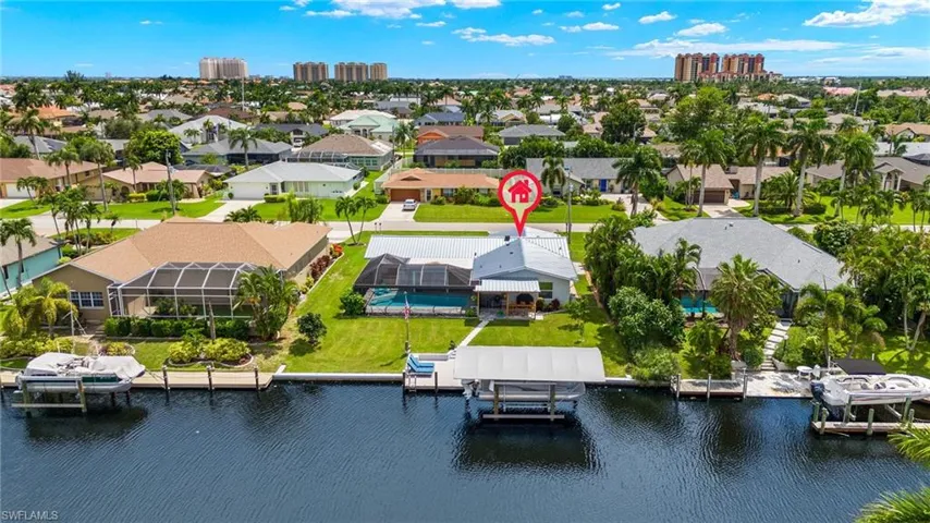 Birds eye view of property with a water view