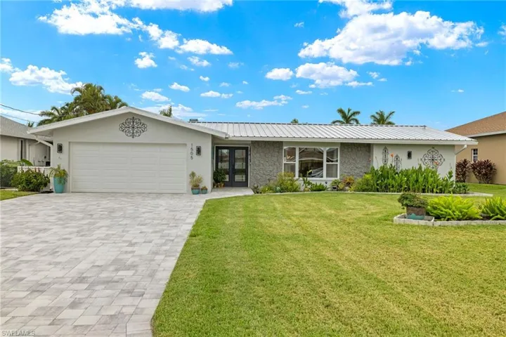 Single story home with a front yard and a garage