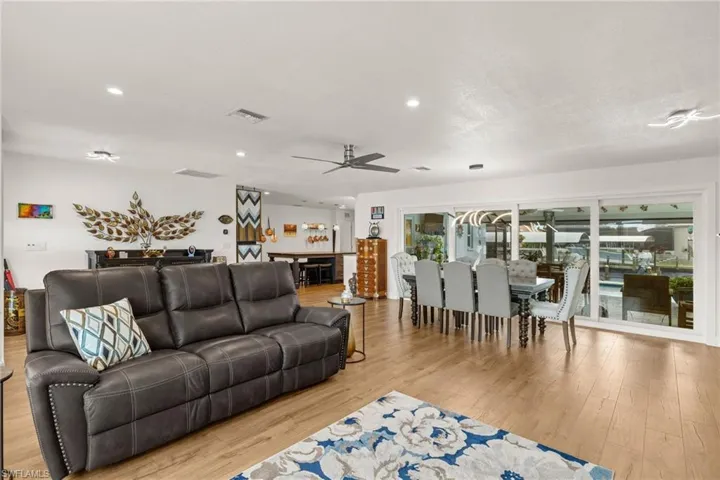 Living room featuring ceiling fan and light hardwood / wood-style floors