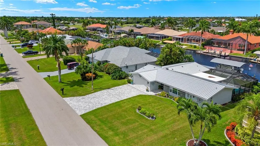 Birds eye view of property with a water view