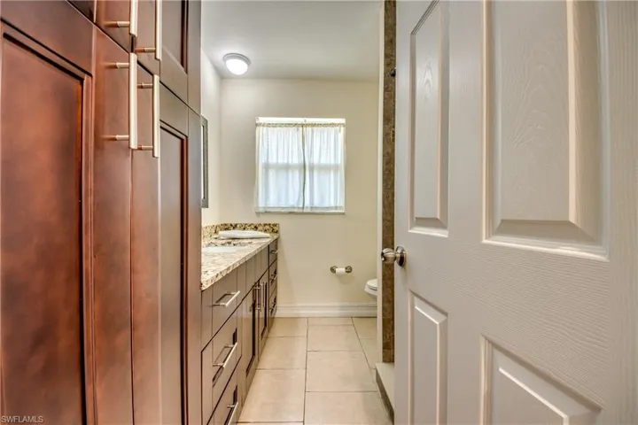 Bathroom with vanity and light tile patterned flooring