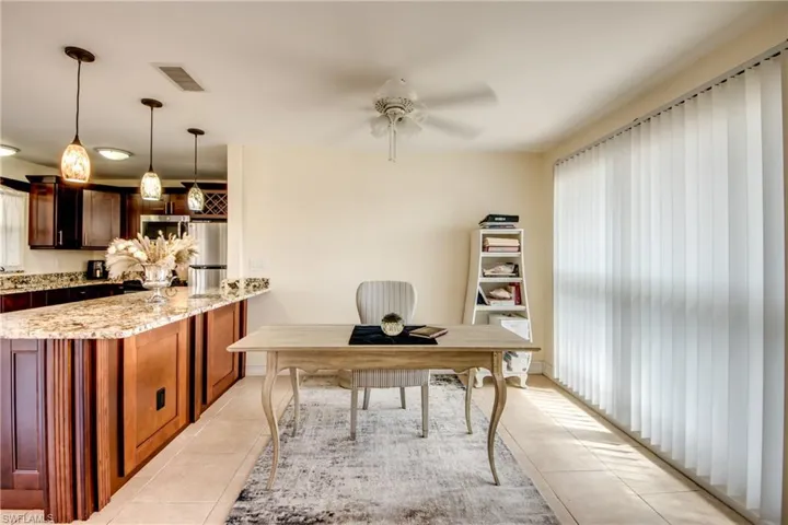 Office area with ceiling fan, healthy amount of natural light, and light tile patterned floors