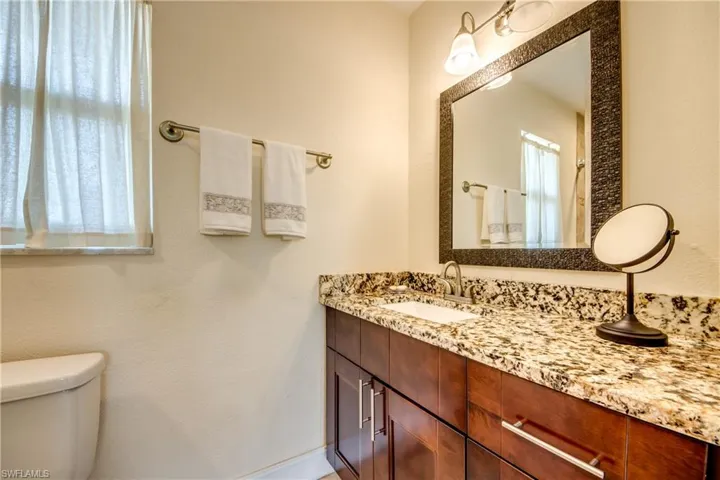Bathroom with vanity and a textured wall