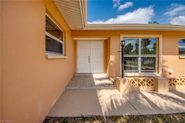 Property entrance with stucco siding