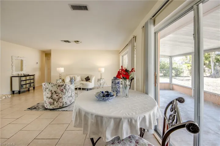 Dining space with light tile patterned flooring