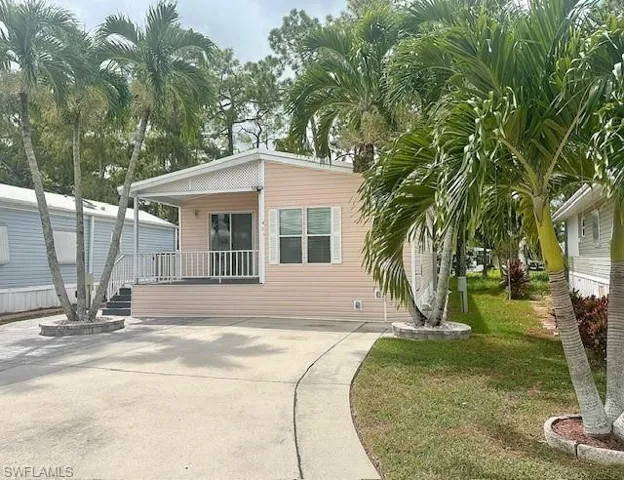 Back of property featuring a yard and a porch