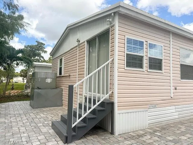 View of side of property with a patio area