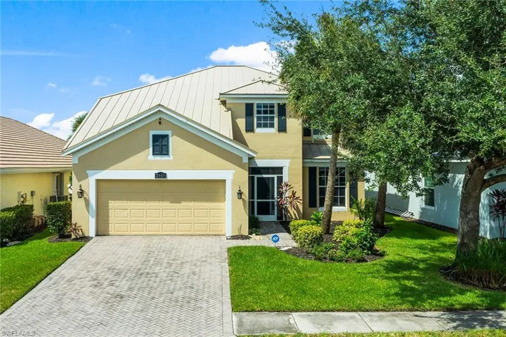 View of front of house with a front lawn and a garage