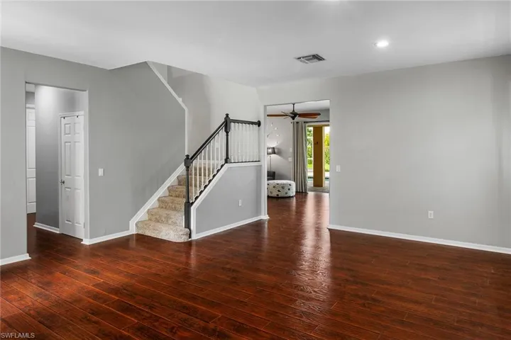 Spare room featuring ceiling fan and dark hardwood / wood-style flooring