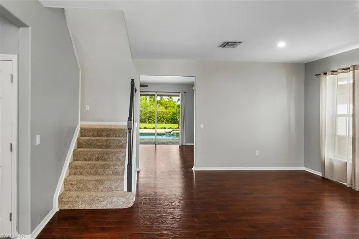 Empty room with dark hardwood / wood-style floors