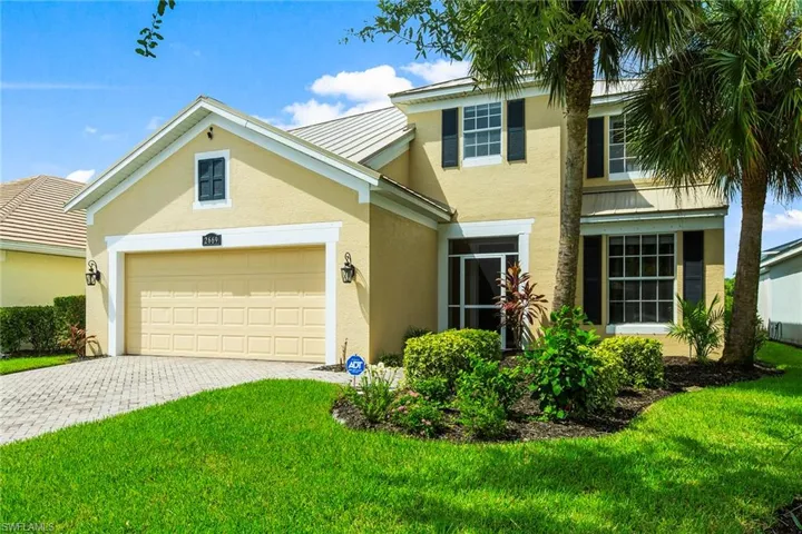 View of front facade with a garage and a front lawn