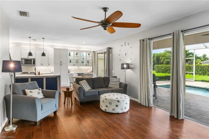 Living room featuring ceiling fan and dark hardwood / wood-style floors